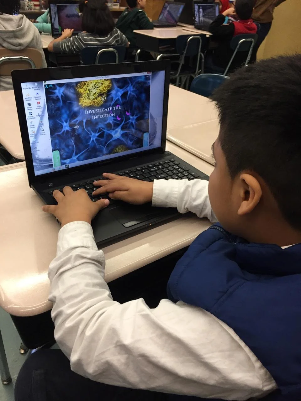Student using the Syndemic educational game on a laptop