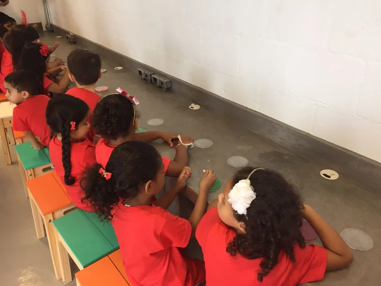 Children seated in a row during a bacteria outreach workshop